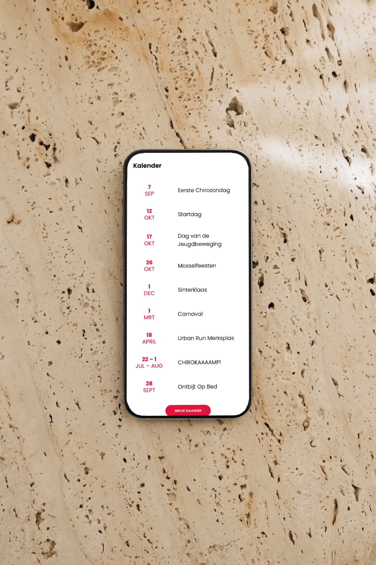 Een iPhone met de kalender van Meisjeschiro Merksplas